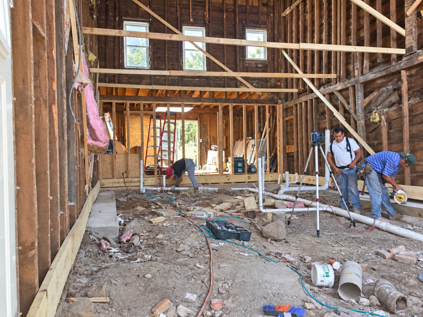 Exposed framing and plumbing · Early renovation work
